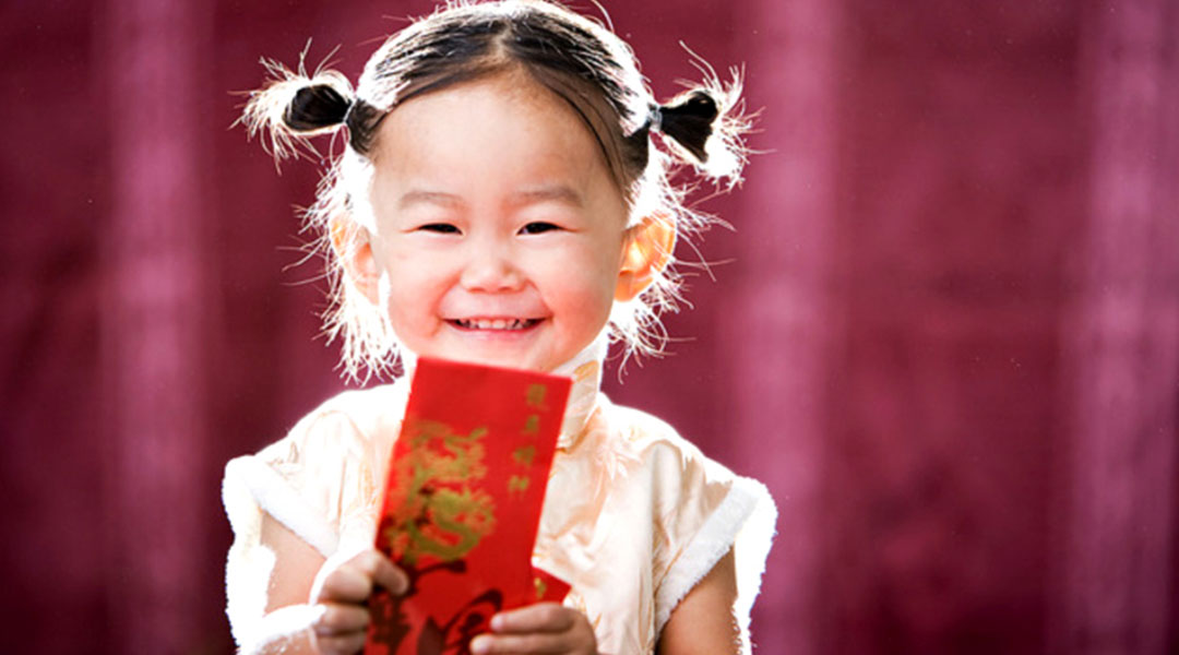 Little girl and Angpao. Children personality in red cheongsam