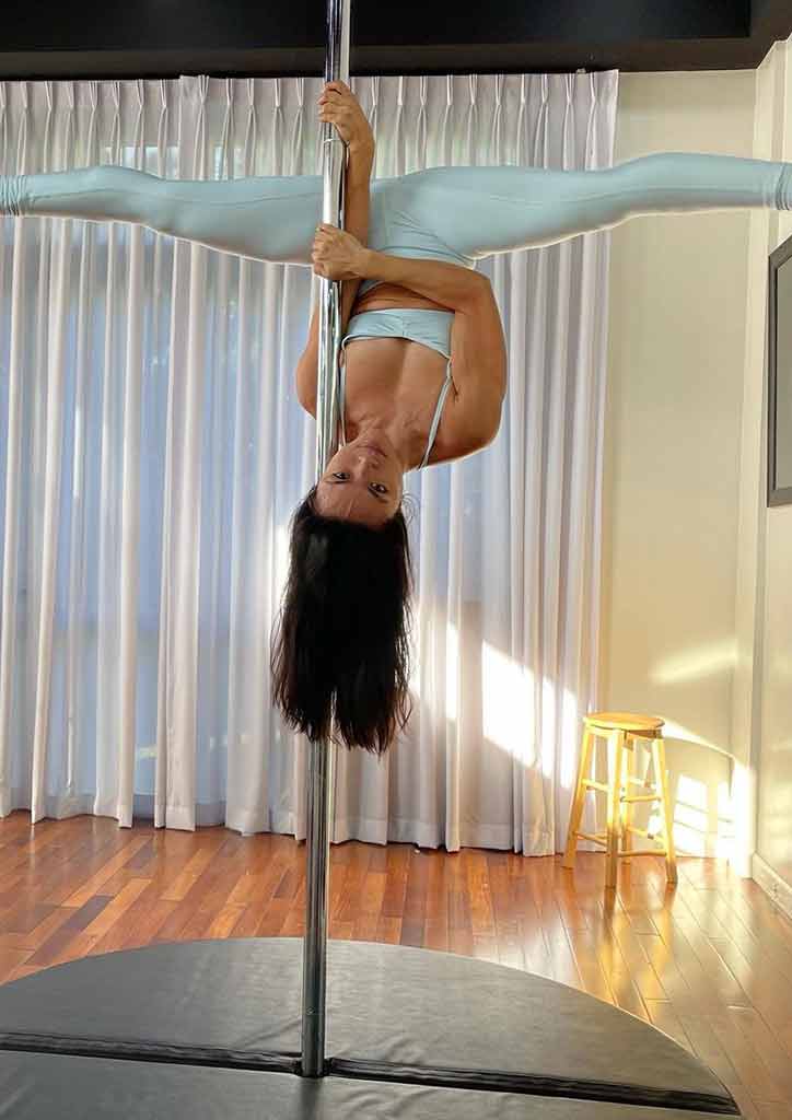 fit mom doing a pole dance pose