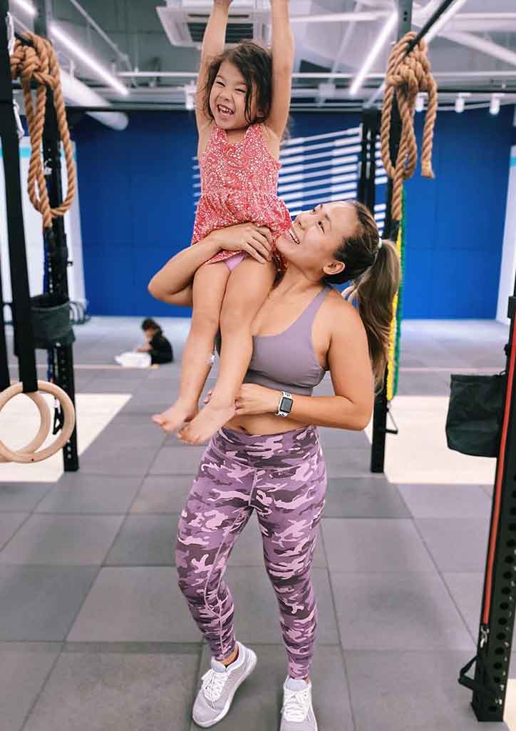 fit mom poses with child 