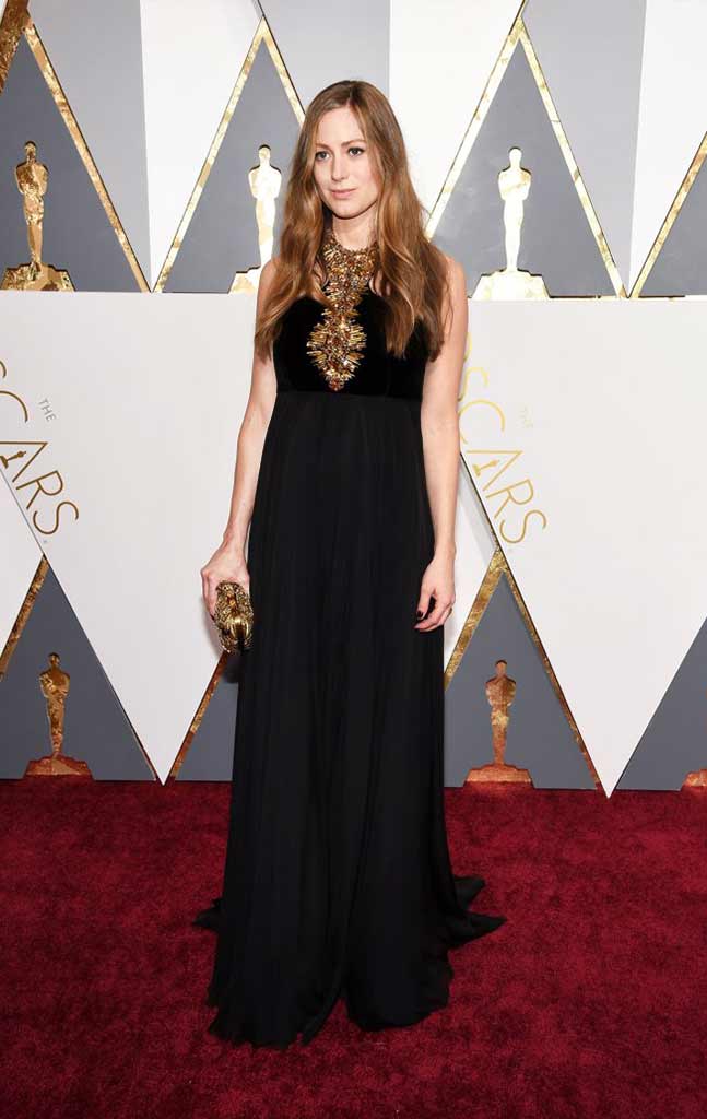 Hannah Bagshawe in a black concealing gown accented with gold for an Oscar's maternity look