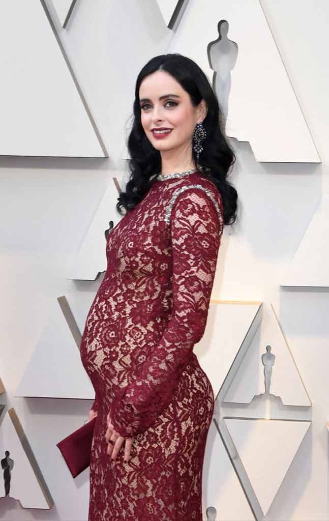 Krysten Ritter in Lacy Red for a maternity look