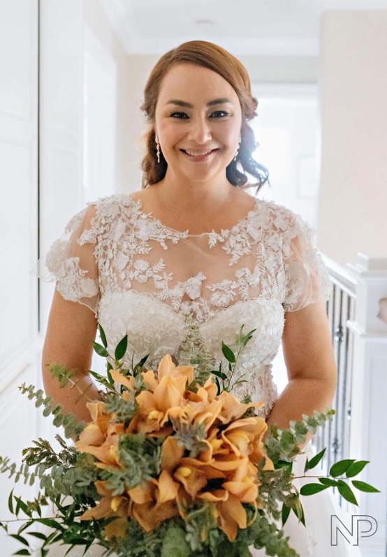Donita Rose in her wedding gown and peach-orange bouquet.
