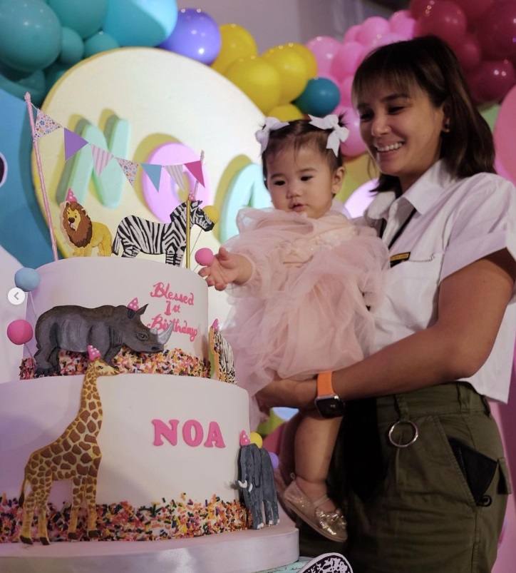 Noa Prats with her mom, celebrity actress Isabel Prats, with their safari themed cake from Hearts and Bells.
