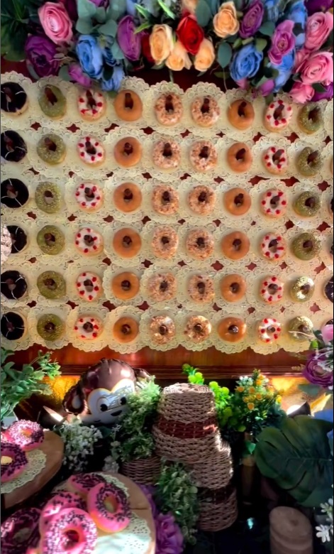 Noa's birthday has a fancy donut wall for kids and parents to enjoy.