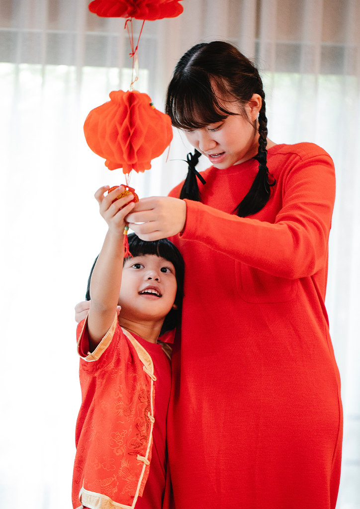 A mother and child in red celebrating Chinese New Year