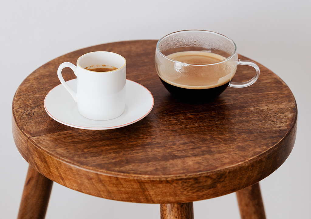 Two cups of coffee on a small stool