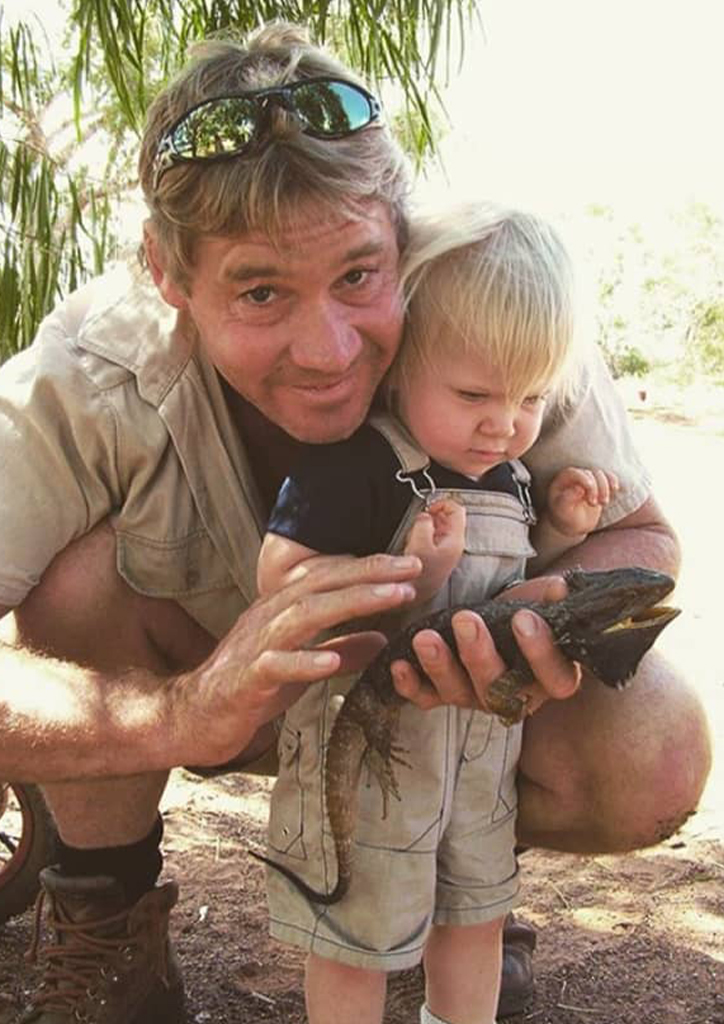 Steve Irwin with his child and a reptile