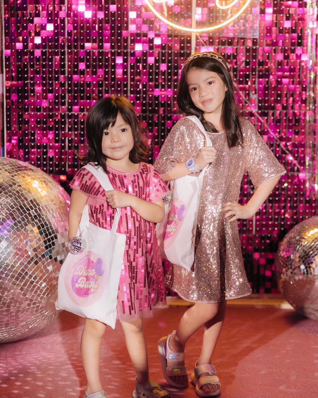 Amelia and Olivia in their pink dresses for Andi Manzano's disco-themed baby shower