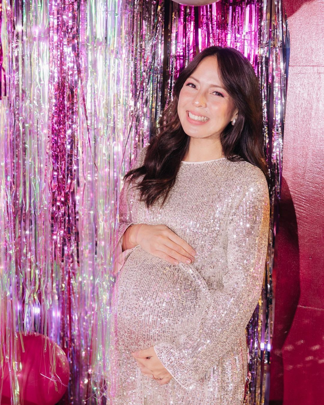 Andi Manzano at her baby shower wearing a sparkly dress