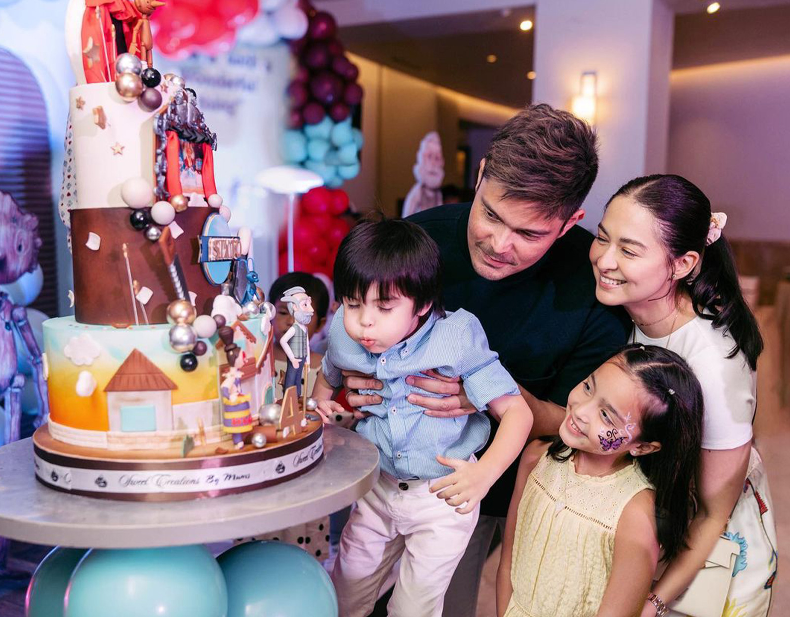 Sixto Dantes blowing his Pinocchio-themed birthday cake