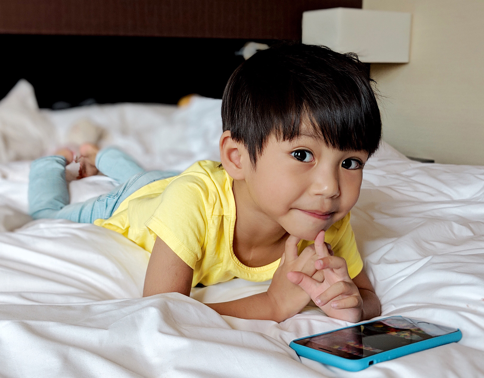 A little boy playing a mobile game