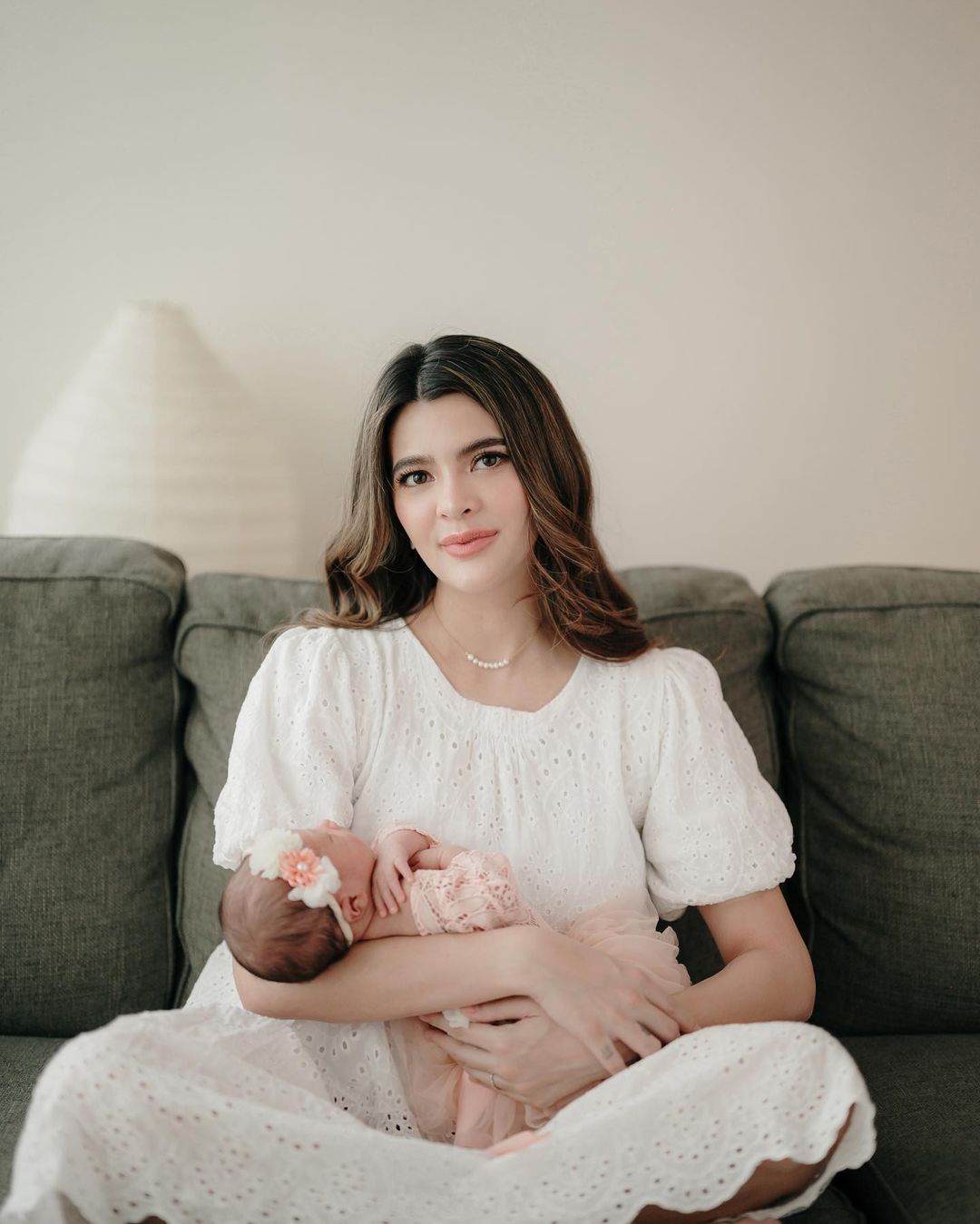 Celebrity mom Katarina Rodriguez posing with her new baby girl, Clara.
