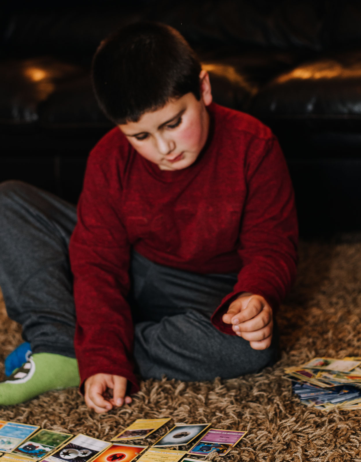 A child playing with his Pokemon cards