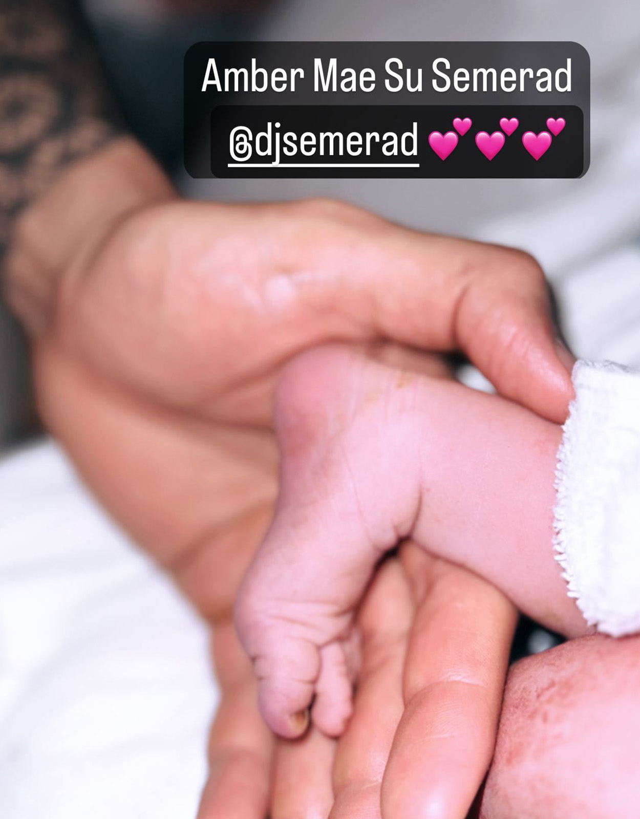 Gwen Zamora holds her baby's hand