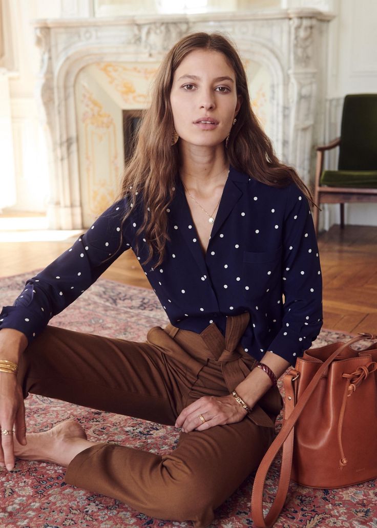 A woman in a blue polka dot blouse for New Years