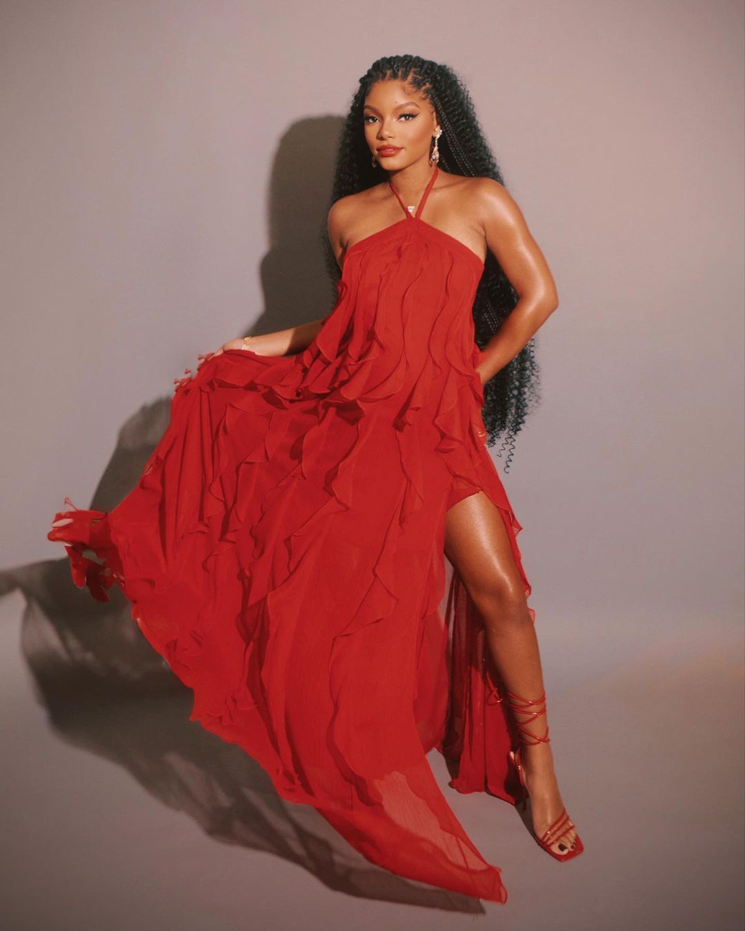 Halle Bailey in a flowing, ruffled red gown