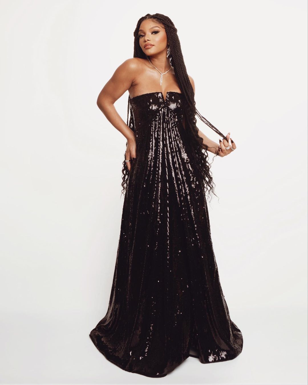 Mom-to-be Halle Bailey in a glittering black Gucci floor-length dress.