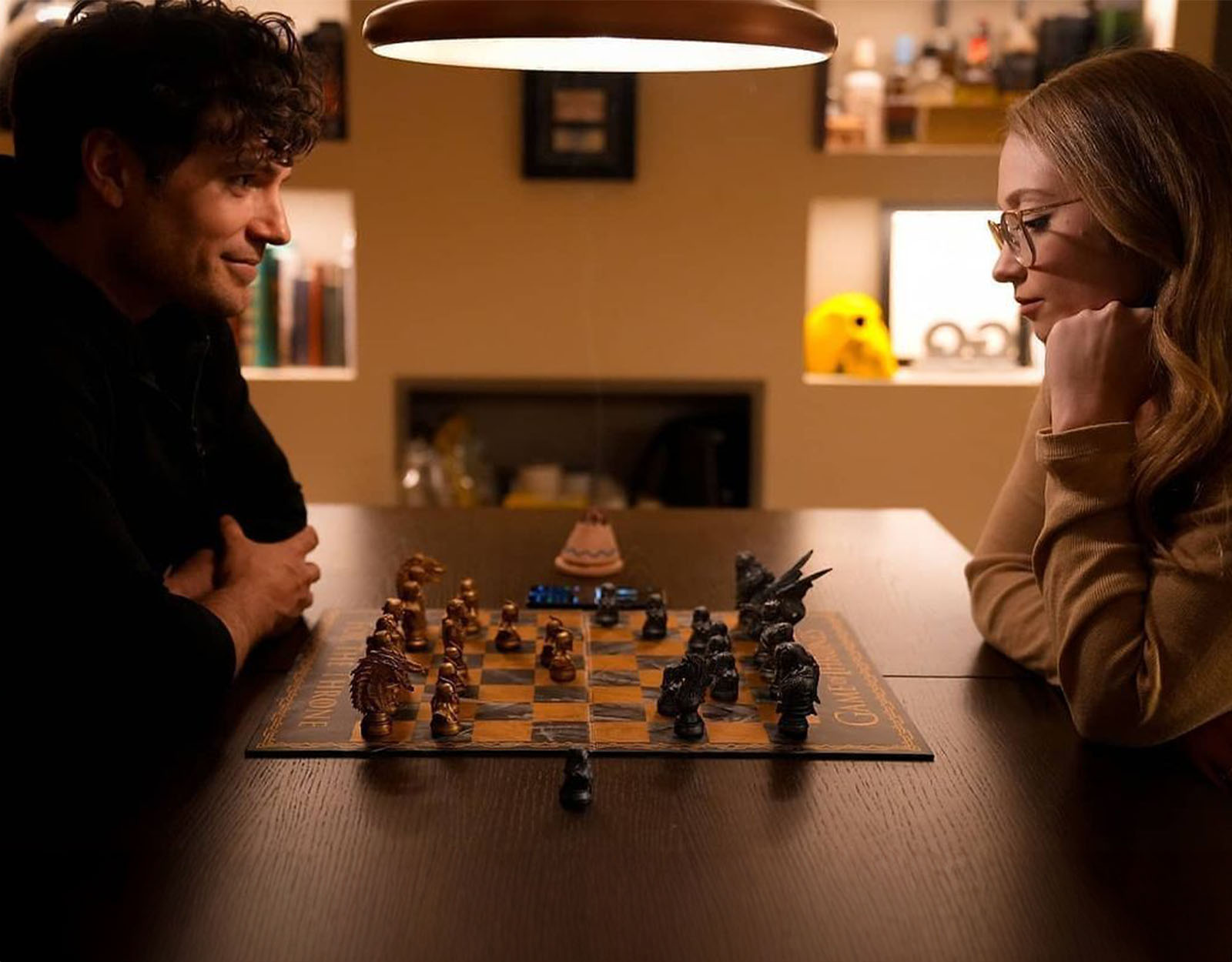 Henry Cavill and Natalie Viscuso playing chess
