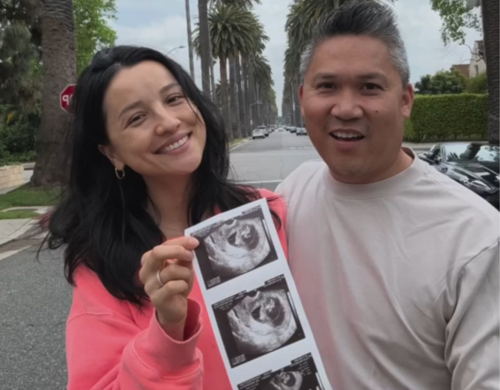 Dante Basco and Alice Rehemutula posing with the sonogram of their first baby